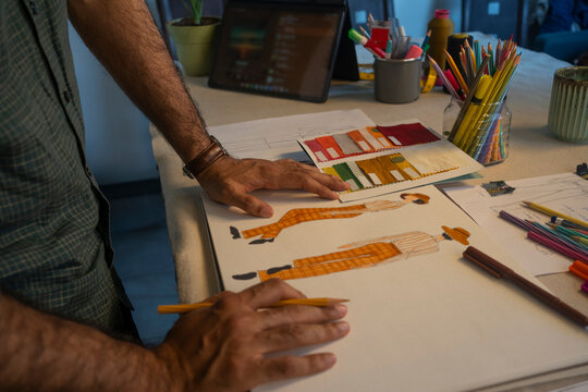 A Fashion designer working on sketches for his next collection