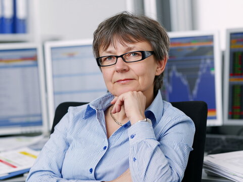 Concentrated Individual Analyzing Data on Computer at Tidily Arranged Workstation with Soft Ambient Lighting, Conveying Focus and Persistence