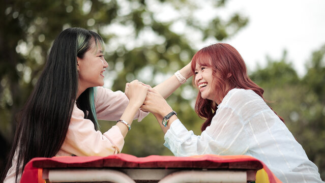Happy LGBTQ+ couple sharing joyful moments together in the park, celebrating love, equality, diversity, inclusion and friendship