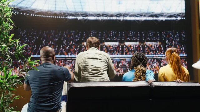 Soccer supporters pleased by positive live soccer game result as immersive TV transports them close to the field while football fans celebrate a goal at home.