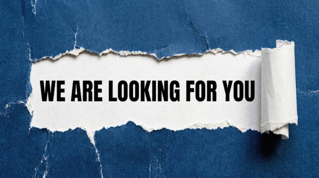 Torn paper with 'We are looking for you' message. Recruitment or job search concept.