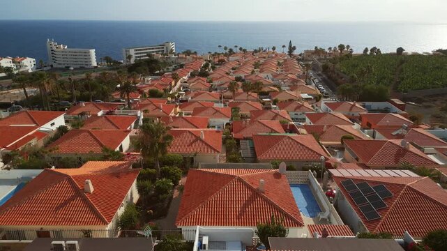 luxury villa district on Tenerife, houses and homes with orange tile, aerial drone view 4k