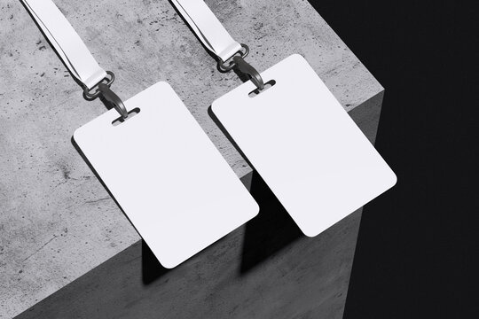 Two white ID card badge with lanyard on concrete and black background for mockup template