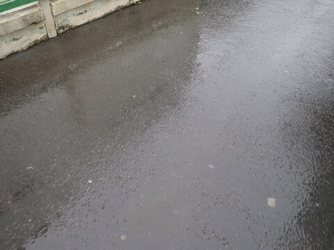 wet gray street tile in the rain