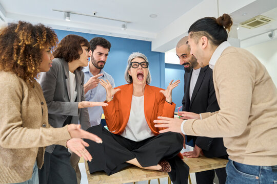 Overwhelmed businesswoman screaming during conflict in office