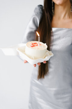Bento Cake with Birthday Candle Held by Woman