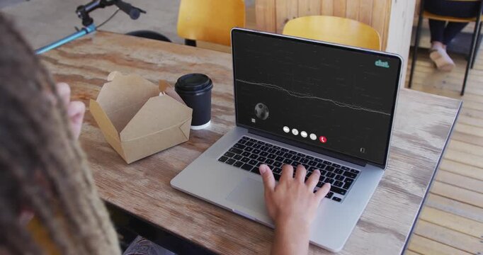 Male friends reacting to laptop call at cafe right typing while left handling takeout and coffee