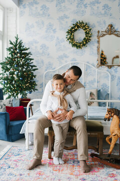 Father Hugging Son In Festive Home Interior