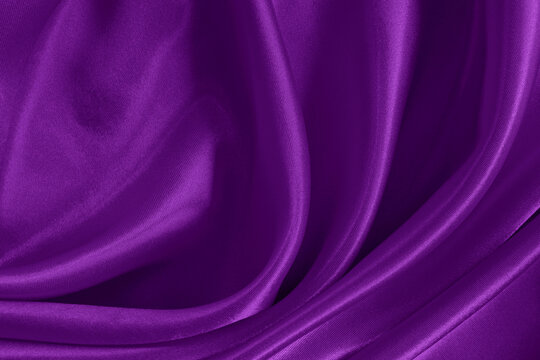 Dark purple fabric texture background, detail of silk or linen pattern.
