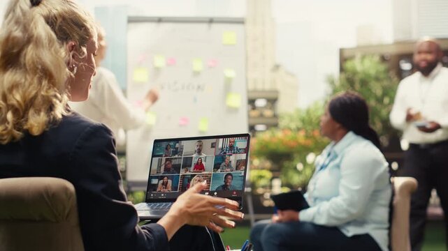Businessperson attending video call conference for remote collaboration, virtual presentation and video meeting with coworkers, modern outdoor work with conference call, for outdoor productivity.