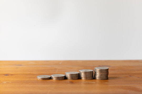 Money coin stacks for finance investment and savings on wooden table