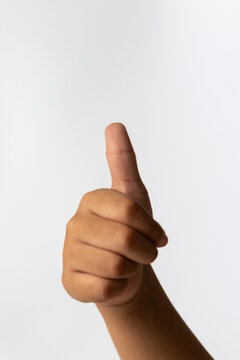 Child hand showing thumbs up gesture for kid approval and success