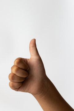 Child hand showing thumbs up positive agreement gesture