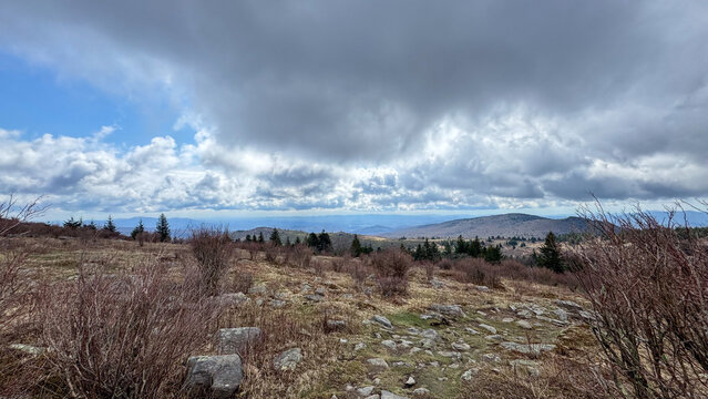Dramatic clouds above distant blue mountain ridges