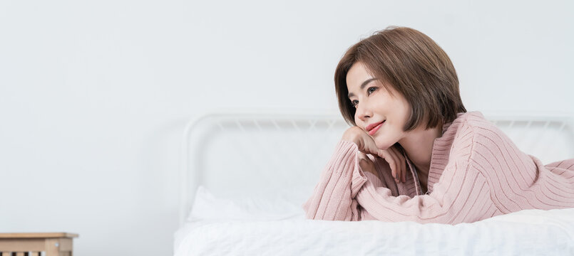 Portrait smile happy beautiful asian woman relax bedroom Asian girl face winter cloth Beauty short hair spa woman treatment perfect clear cosmetology skin Japanese girl makeup hygge lifestyle