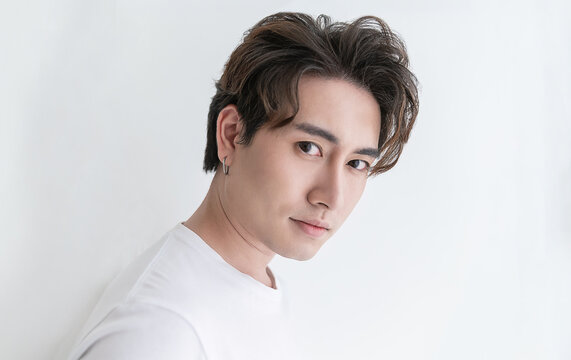 Attractive young handsome smiling face positive asian, korean happy casual man, stay home minimal lifestyle. Closeup portrait of asia middle age 20s man wearing white shirt in studio. Young model boy