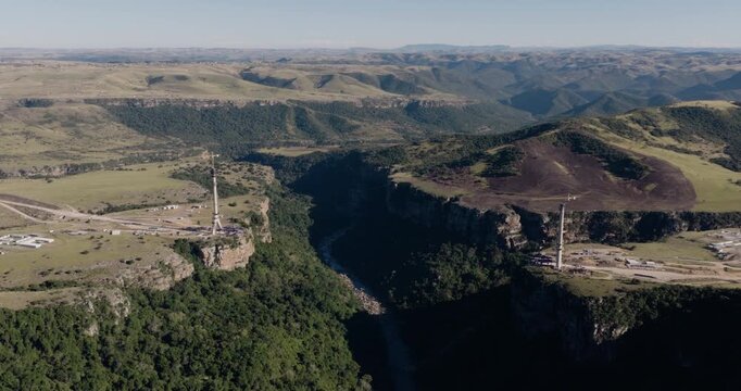 Wide aerial zoom in view of the construction of Msikaba Bridge in the Eastern Cape, South Africa. It will span 580 meters across the Msikaba River gorge and stand 194 meters high. Economic development