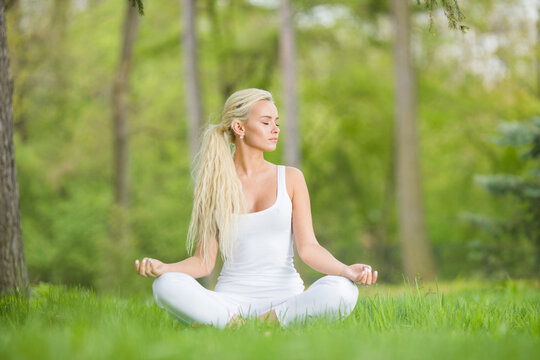 Serene Female Yogi Practicing Mindfulness Outdoors on Green Grass
