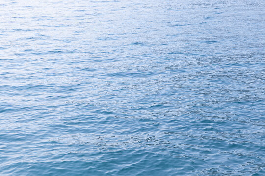 Light blue lake water surface with ripple pattern, natural abstract background photo texture