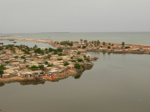 Africa, Angola, Luanda, elevated view of residential structures and trees by sea against sky