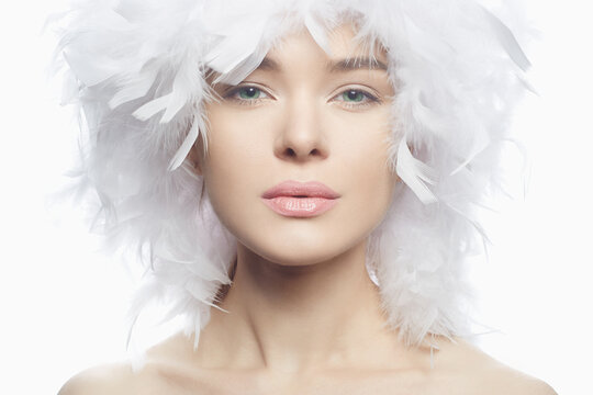 Beautiful young woman with creative white feathers headwear