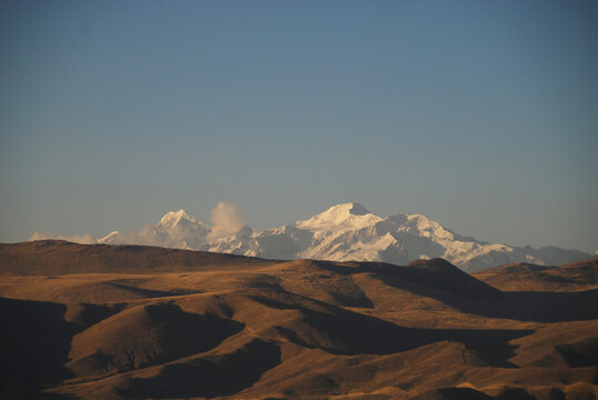 Bolivia, Inland, majestic view of island amidst river with dirt road in foreground against blue sky