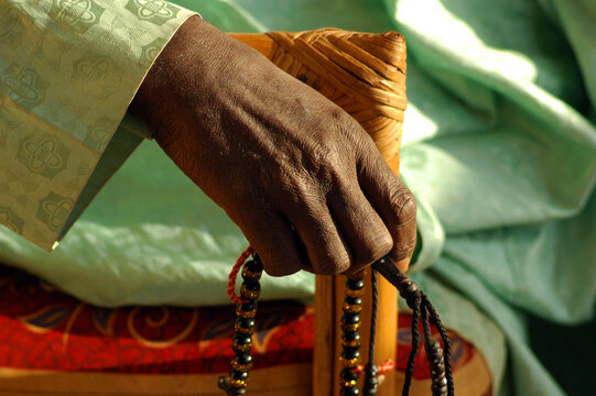 Black hand holding a muslim prayer chaplet