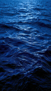 Deep blue ocean waves under soft evening light.