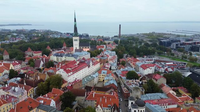 Explore Tallinn City from above as it showcases its rooftops and historical buildings on a cloudy day in autumn
