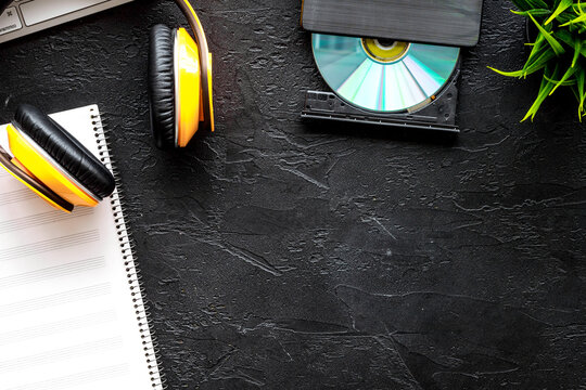 Headphone with paper note in music studio for dj or musician work on dark background top view mock-up