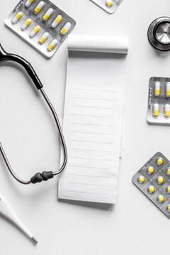 doctor's work with stethoscope and copybook on hospital desk background top view mock up