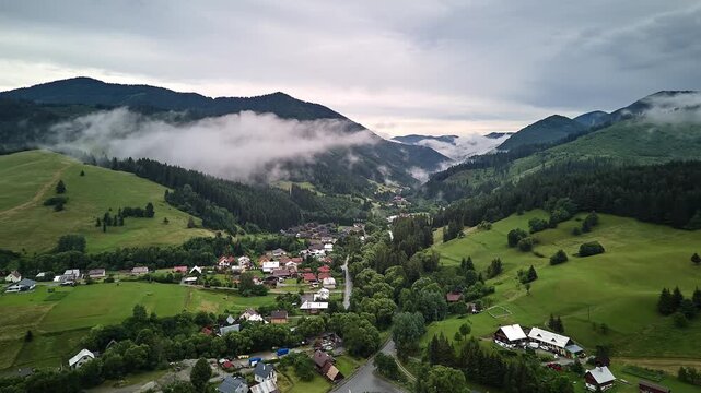 Aerial Hyperlapse Mountain Valley Village With Fog Drifting Over Slopes at Dawn