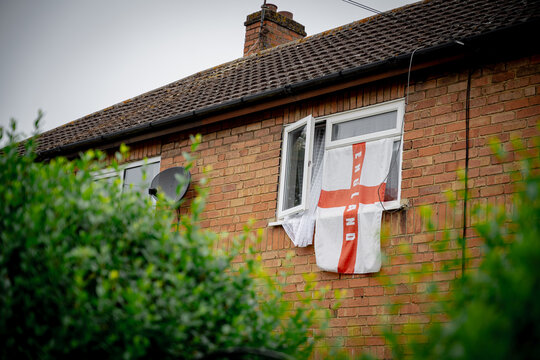 Corby, Northamptonshire, United Kingdom - July 15, 2026: England flag hanging from house window in residential neighborhood
