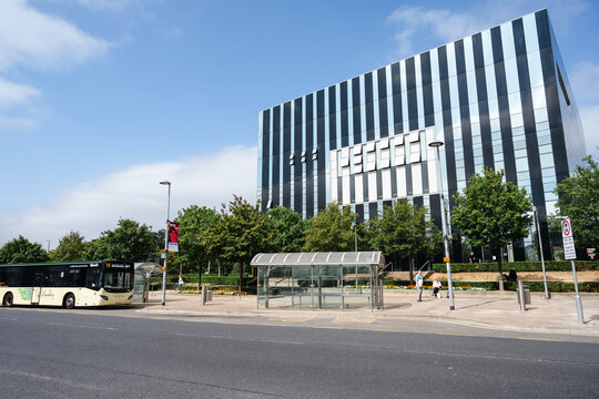 Corby, Northamptonshire, United Kingdom - July 15, 2026: Modern office building with bus stop in contemporary urban business district