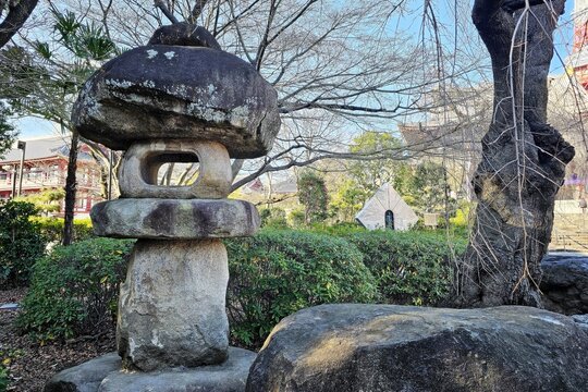 Traditional Japanese stone lantern or toro in the garden of Zojoji Temple, Tokyo.