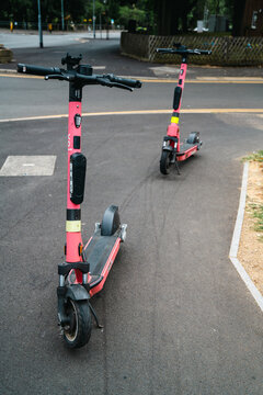 Corby, Northamptonshire, United Kingdom - July 15, 2026: Electric rental scooters parked on urban street for shared micromobility transport
