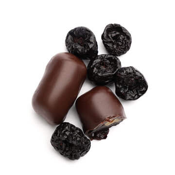 Sweet chocolate covered prunes on white background