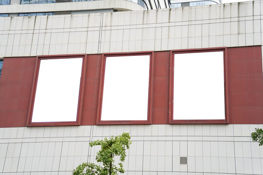 Triple blank billboards and high rise business building
