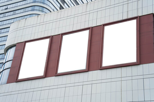 Triple blank billboards and high rise business building
