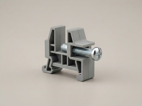 Gray plastic terminal block with metal screw on light background