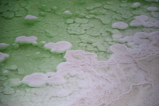 Aerial view of salt crystallization at Emerald Lake (翡翠湖) in Qinghai, China, showcasing vibrant turquoise and green colors of the salt lake.
