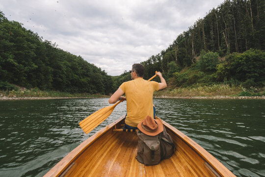 Man enjoying peaceful lake by canoe