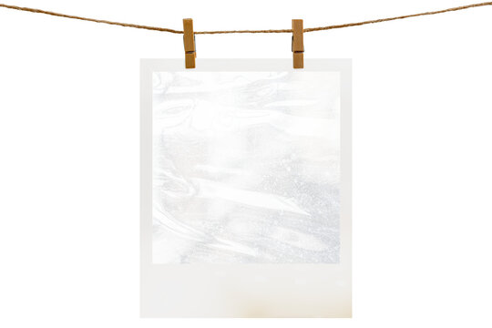 Blank photo frame hanging on a rope with a wooden clothespin. Isolated transparent PNG mockup.