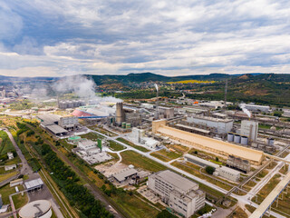 Fototapeta premium Industrial area with factories and machinery in the countryside during the day with clouds in the sky
