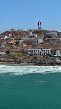 Vertical drone pan left of Cristo del Sagrado Coraz&oacute;n overlooking the Rosarito coast, Baja California