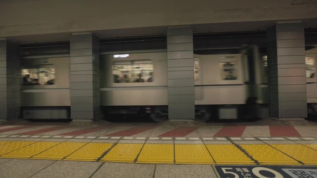 A Modern Train Passing Through a Japanese Railway Station, Showcasing the Clean Design and Efficiency of Public Transportation in Japan - Static Shot