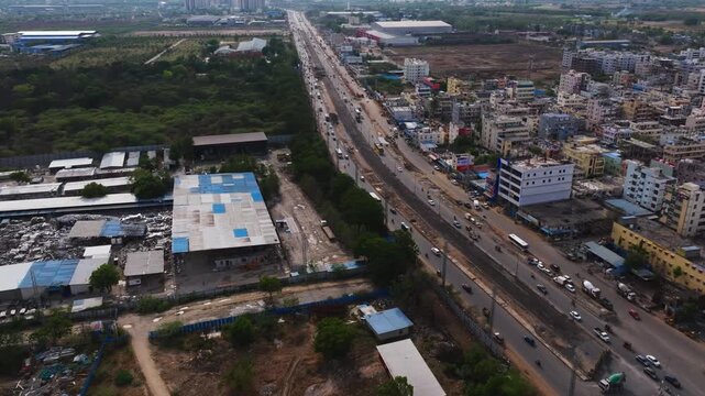 Mumbai highway with traffic flow, buildings and Aparna CSG Metal fabricator at Patancheruvu, Hyderabad, Telangana, india. day time, push in shot, bird eye view, drone shot, 4k.