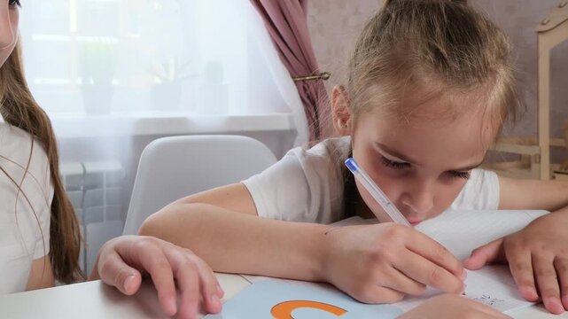 Focused Kids Learning Together in Quiet Home Environment With Gentle Peer Support