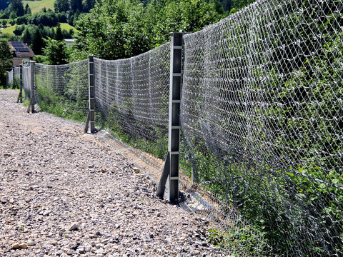 rockfall barrier dynamic rockfall catch fence or debris flow barrier what it is and how it works to intercept, catch, and safely absorb the kinetic energy of falling rocks, boulders, or debris rolling