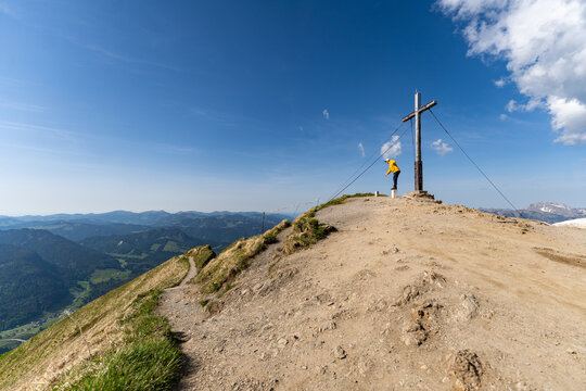 Reaching the summit cross of Fellhorn peak in the Allgaeu Alps